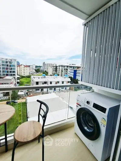 Modern balcony with washing machine and city view, perfect for urban living.