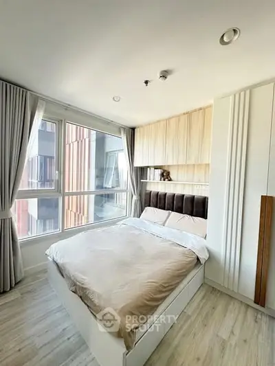 Modern bedroom with large window and stylish decor in urban apartment