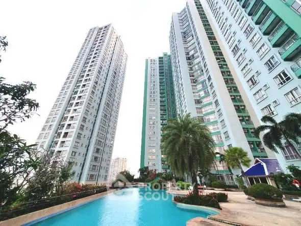 Stunning high-rise residential towers with a luxurious pool and lush landscaping.