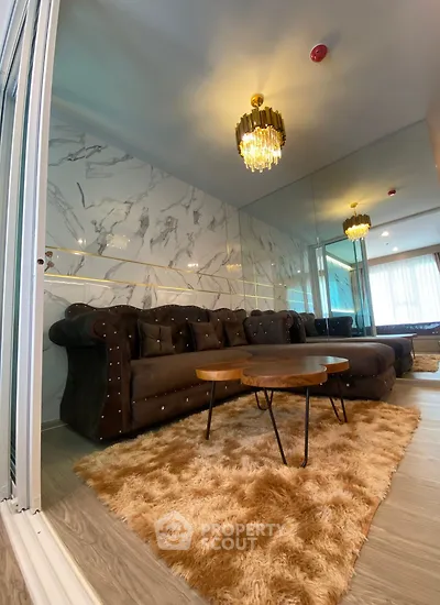 Luxurious living room with elegant chandelier and plush sofa in modern apartment