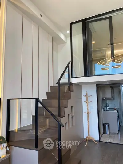 Modern duplex apartment with stylish staircase and open kitchen layout