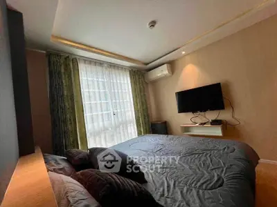 Cozy bedroom with modern decor and natural light in urban apartment.