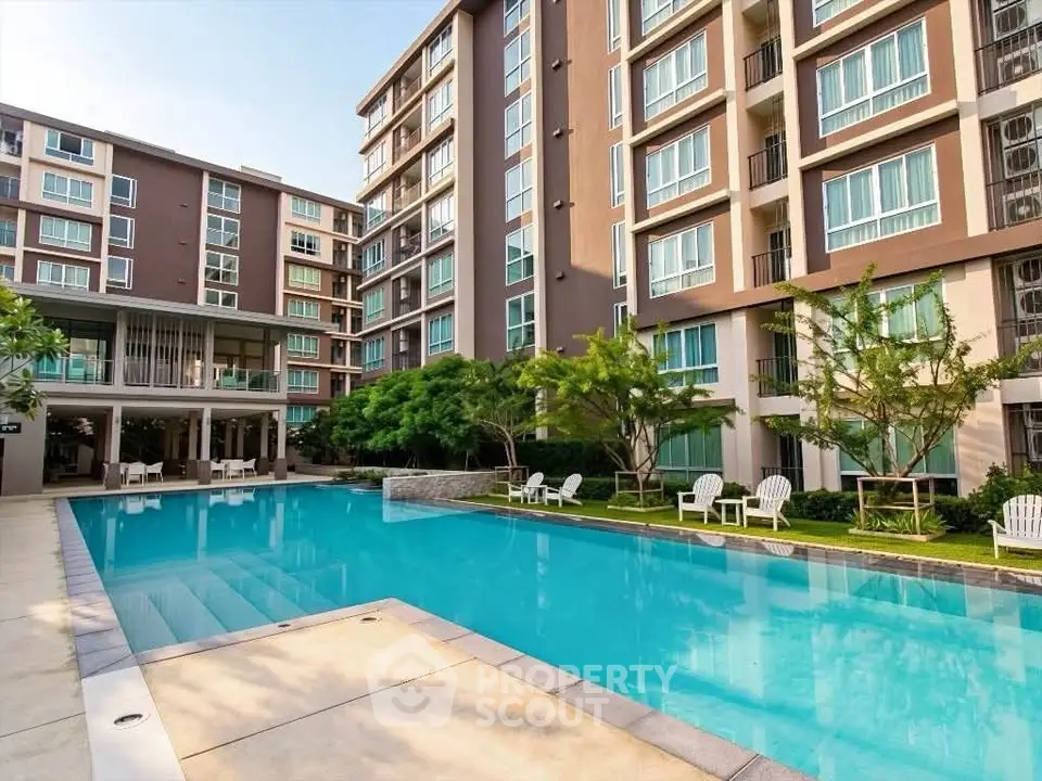 Modern apartment complex with inviting pool and lush greenery, perfect for relaxation and leisure.