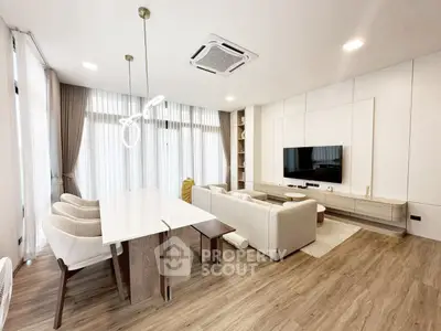 Modern living room with elegant decor and open dining area