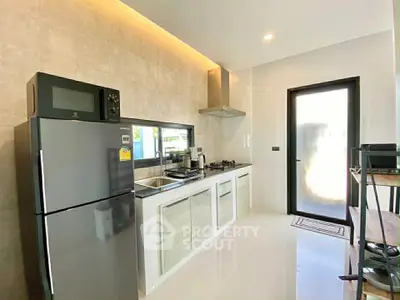 Modern kitchen with sleek appliances and open layout in a stylish home.