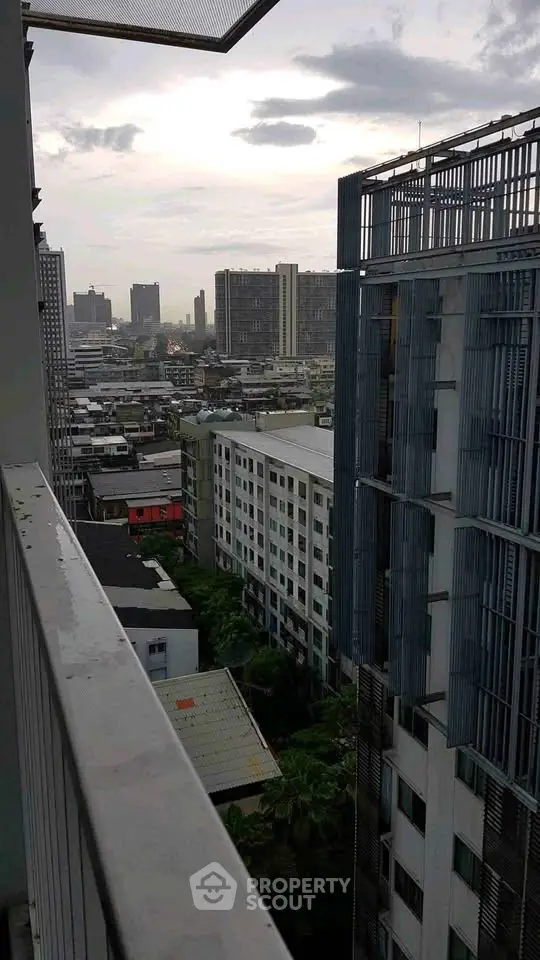 Stunning cityscape view from high-rise balcony overlooking urban skyline.