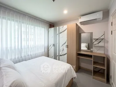 Modern bedroom with stylish wardrobe and air conditioning in a bright apartment.