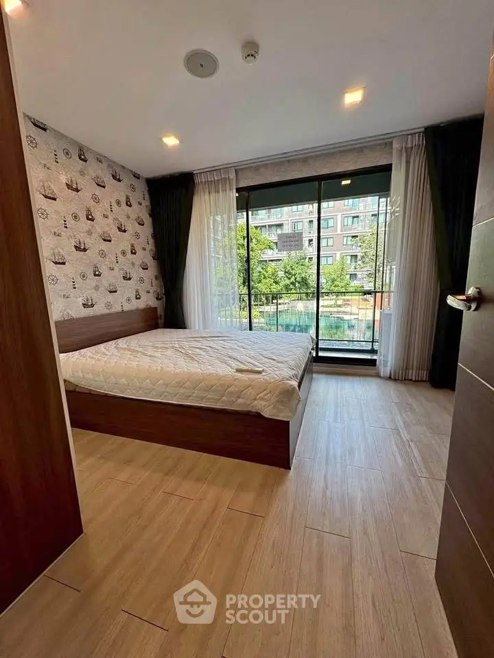 Modern bedroom with large window and balcony view in urban apartment