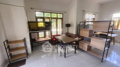 Spacious living room with modern furniture and large windows offering natural light.