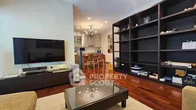 Spacious living room with modern decor and open kitchen layout