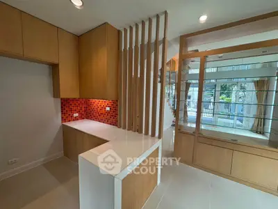 Modern kitchen with open layout and stylish red backsplash