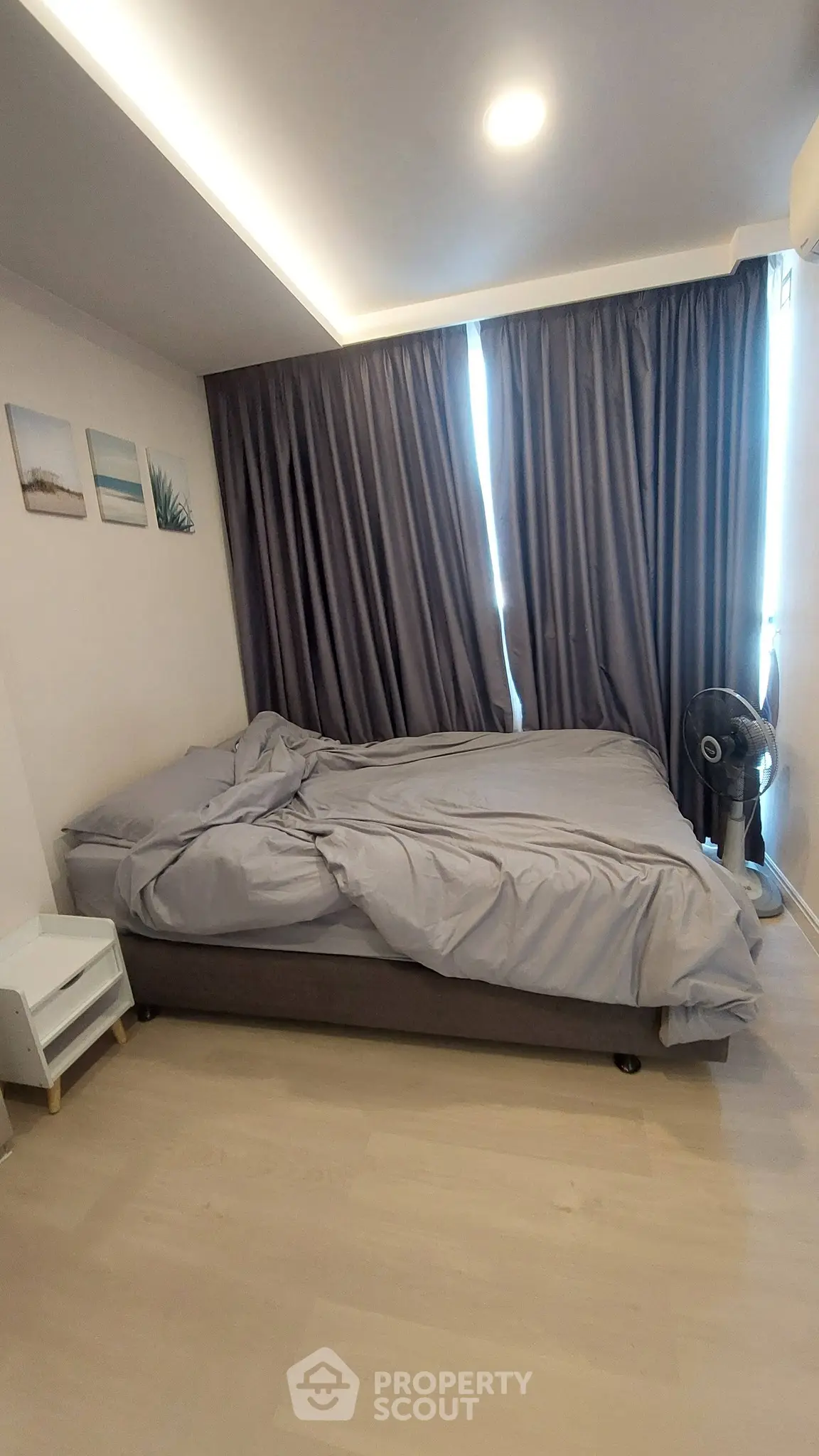 Cozy bedroom with modern decor and soft lighting, featuring a comfortable bed and elegant curtains.