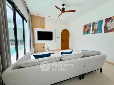 Modern living room with pool view, featuring stylish decor and comfortable seating.