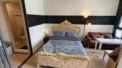 Luxurious bedroom with ornate bed, cozy seating, and modern ensuite bathroom in a high-rise apartment.