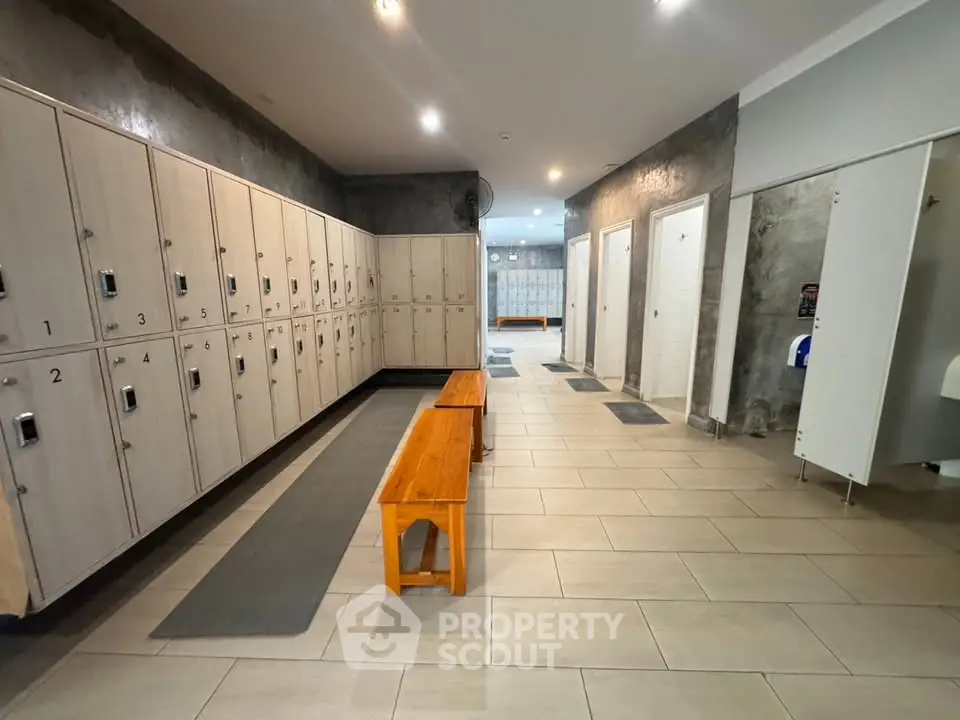 Spacious gym locker room with modern lockers and benches