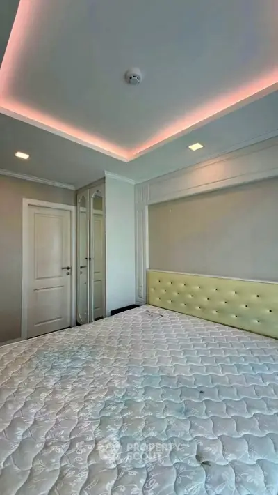 Modern bedroom with stylish ceiling lighting and elegant decor