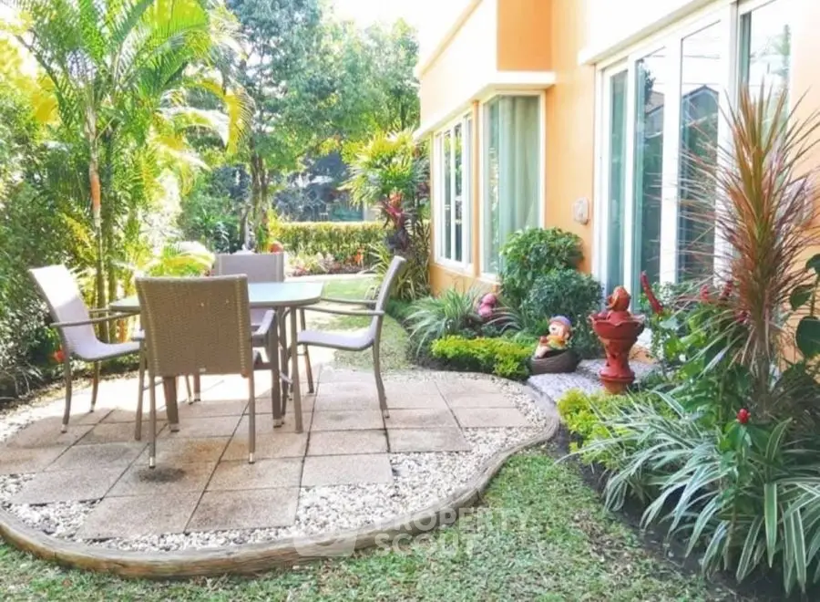 Charming garden with outdoor dining set and lush greenery