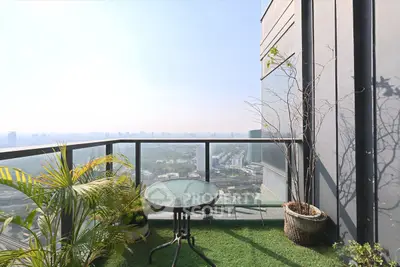 Stunning high-rise balcony with panoramic city views and lush greenery, perfect for relaxation and entertaining.