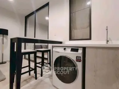 Modern kitchen with washing machine and sleek bar counter