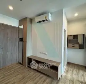 Modern living room with wooden flooring and air conditioning unit