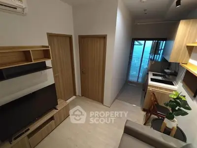 Modern compact living room with open kitchen and stylish decor