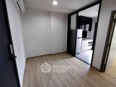 Modern apartment interior with sleek kitchen and wooden flooring, perfect for urban living.
