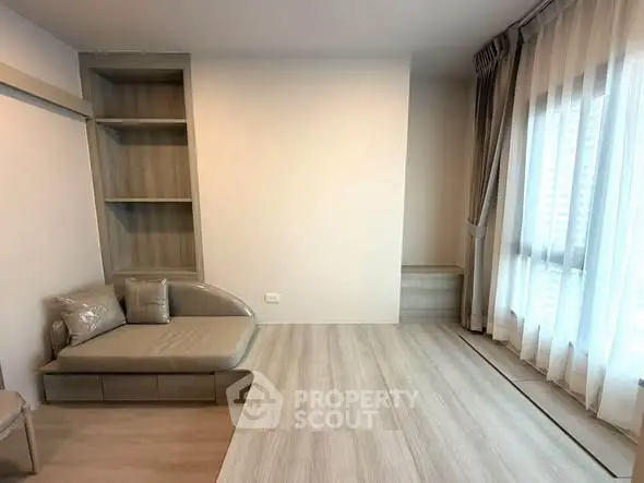 Modern minimalist living room with built-in shelves and large window