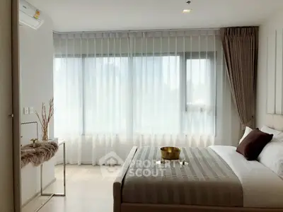 Elegant bedroom with modern decor and large windows for natural light