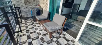 Stylish balcony with modern furniture and city view, perfect for relaxation.