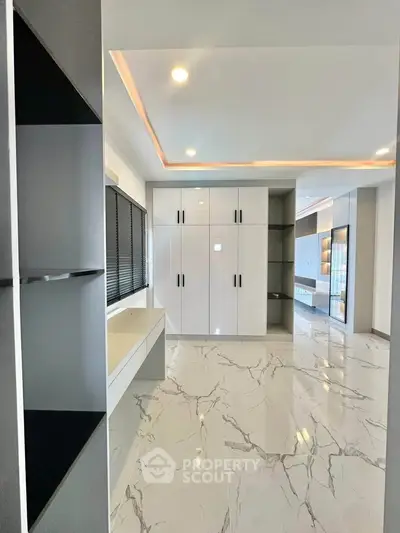 Luxurious modern interior with marble flooring and sleek cabinetry, perfect for contemporary living.