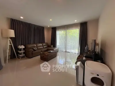 Spacious living room with modern decor and large windows offering natural light.