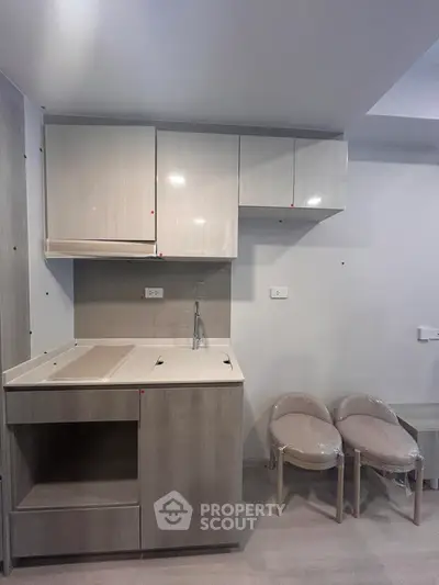 Modern compact kitchen with sleek cabinetry and minimalist design