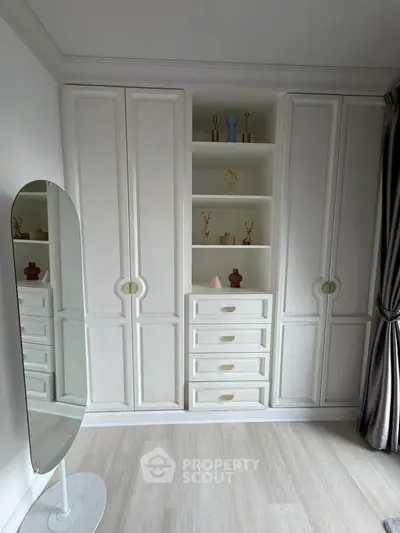Elegant bedroom with built-in white wardrobe and decorative shelves