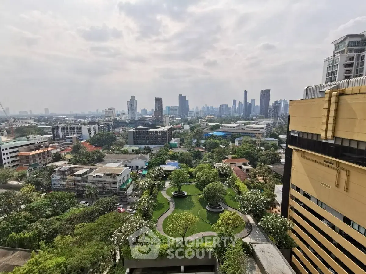 Stunning cityscape view from high-rise building with lush green park below, showcasing urban living at its finest.