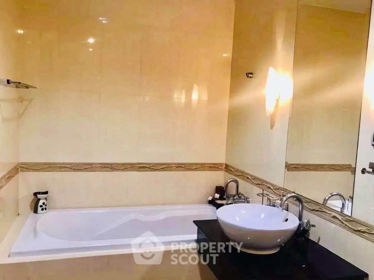 Elegant bathroom with modern fixtures and a luxurious bathtub in a stylish real estate property.