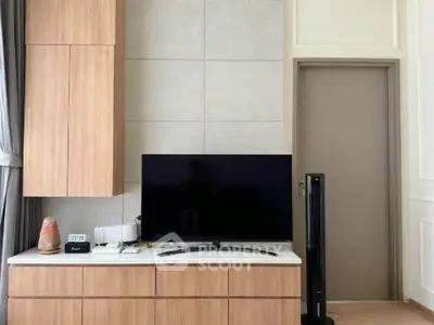 Modern living room with sleek TV setup and stylish wooden cabinetry