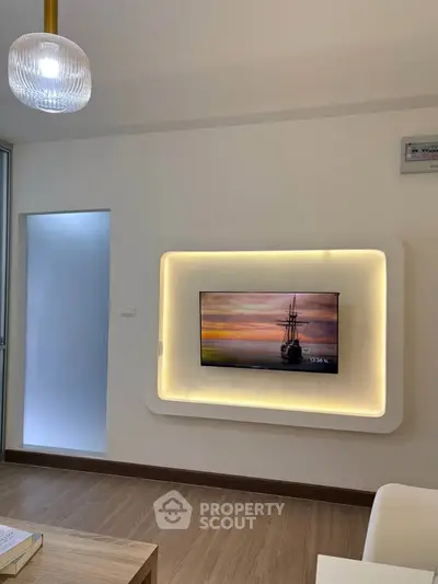 Modern living room with stylish wall-mounted TV and elegant lighting