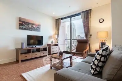 Spacious living room with modern furniture and city view balcony in high-rise apartment.