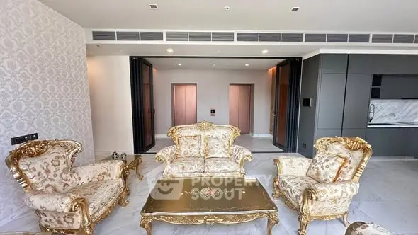 Luxurious living room with ornate furniture and modern kitchen in elegant apartment.