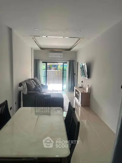 Modern living room with sleek furniture and natural light, perfect for relaxation and entertainment.