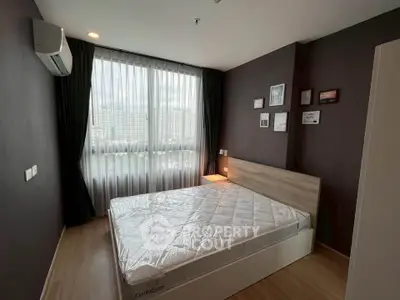 Modern bedroom with large window and stylish decor in urban apartment