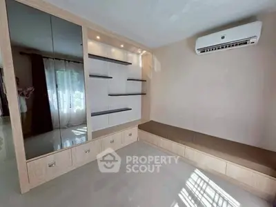 Modern living room with built-in shelves and air conditioning