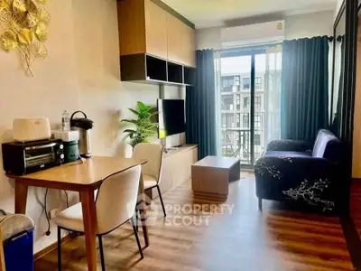 Modern living room with stylish decor and balcony view in urban apartment.