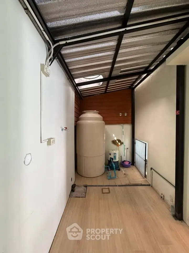 Spacious storage area with water tank and modern flooring