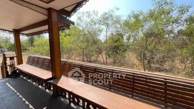 Charming wooden balcony with scenic nature view, perfect for relaxation.