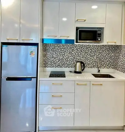 Modern kitchen with sleek appliances and stylish mosaic backsplash