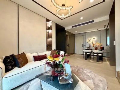 Luxurious modern living room with elegant decor and open dining area, featuring stylish lighting and plush furnishings.