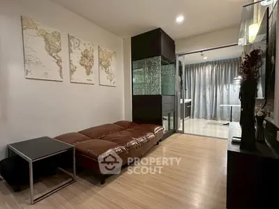 Modern living room with stylish decor and glass partition, featuring a cozy brown sofa and world map art.