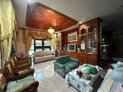 Elegant living room with luxurious wooden ceiling and classic furniture, perfect for sophisticated gatherings.
