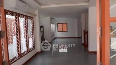 Spacious open layout living area with large windows and air conditioning